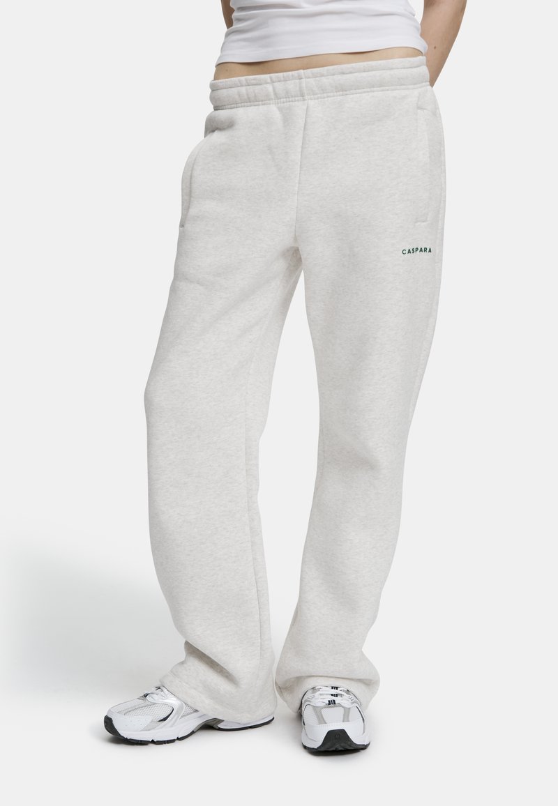 Vaaleanharmaat verkkarit, joissa on vyötärö, sivutaskut ja pieni vihreä logo. Valmistettu pehmeästä materiaalista, rento malli ja suorat lahkeet.