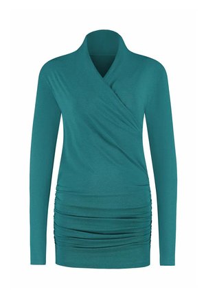 Haut enroulé à manches longues de couleur sarcelle avec des détails froncés sur le bas devant et un col haut replié.