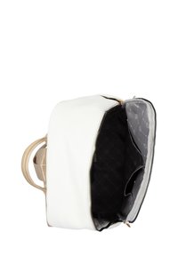 White faux leather bag with beige detailing. Zipper closure opens to a black inner lining featuring a quilted pattern and pockets.