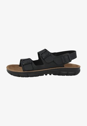 Black sandal with two adjustable buckles, a cushioned brown footbed, and a textured black rubber sole for grip.