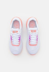Zapatillas deportivas blancas con material de malla, acentos degradados de rosa a morado, puntera redonda y cordones planos, con una suela texturizada.