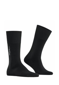 Un paio di calzini neri a metà polpaccio con polsini a costine, uno dei calzini mostra il testo del logo laterale in bianco su uno sfondo bianco.