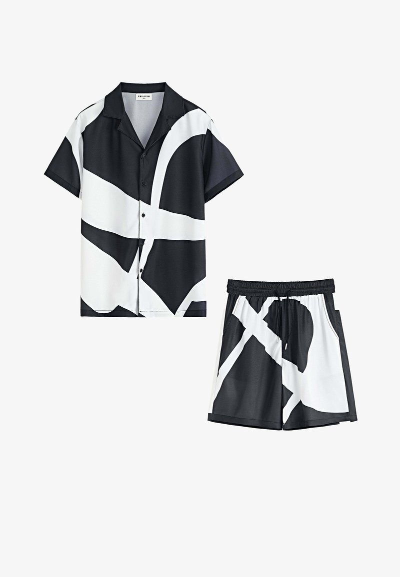 Chemise à manches courtes noire et blanche et shorts assortis, présentant des motifs abstraits, un tissu lisse et une ceinture élastique sur les shorts.