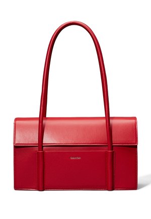 Red rectangular leather handbag with long rounded handles and front pocket, featuring subtle Calvin Klein logo on front panel.