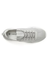 Light grey athletic shoe with a mesh upper, rounded toe, lace-up design, and a pull tab at the heel. White rubber sole.