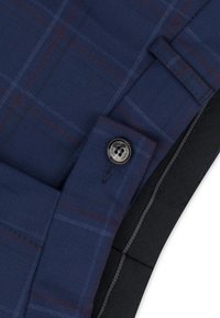 Granatowe i ciemnoszare spodnie w kratę o gładkiej fakturze, z zapięciem na guzik i starannie wykonanymi szwami. Mogą być potencjalnie odpowiednie do noszenia na formalne okazje.