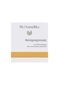 Dr. Hauschka cleansing mask in a white box with a yellow accent stripe. Features brand name and product description in gray text on the front.