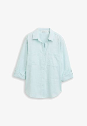 Lichtblauw overhemd met knopen, gemaakt van gestructureerde stof, voorzien van twee borstzakken en opgerolde mouwen. Klassiek kraagontwerp.