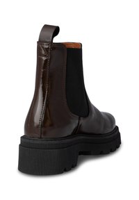 Brown patent leather Chelsea boot with elastic side panels, textured black rubber sole, and a pull tab on the heel for easy wear.