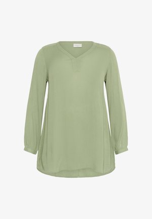 Blouse à manches longues, en V, en tissu doux de couleur vert clair avec une finition texturée et un ourlet arrondi. Présente des manches légèrement bouffantes.