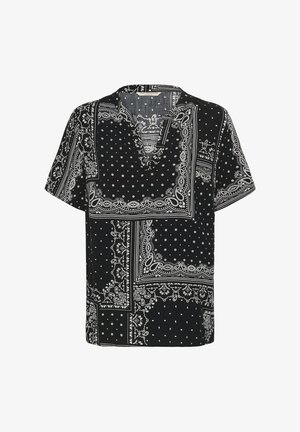 Blusa nera a maniche corte con scollo a V, decorata con motivo patchwork bianco a paisley e pois.