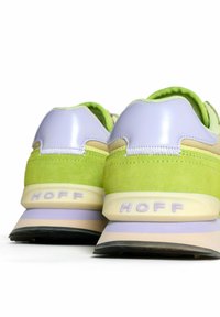Green suede sneakers with lilac accents, featuring a textured design, padded collar, and prominent "HOFF" branding on the heel.