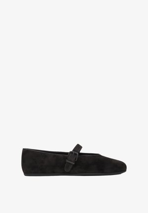Black suede ballet flats featuring a rounded toe and a buckle strap across the instep. Smooth texture with a flat, flexible sole.