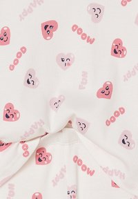 White fabric with pink and red heart emojis showing various facial expressions and words "GOOD," "MOOD," and "HAPPY" printed repeatedly.