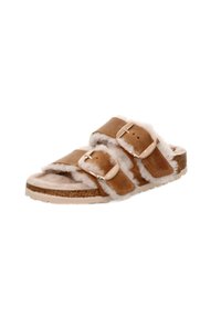 Brown shearling slide sandal with two adjustable straps, a soft footbed, and a textured cork midsole; features gold-tone buckles.