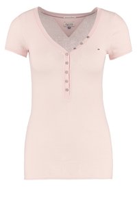 Rosa ribbad t-shirt med V-ringning, korta ärmar och sexknäppt fram. Tillverkad av ett mjukt tyg med en figurnära passform och subtil logodetalj.