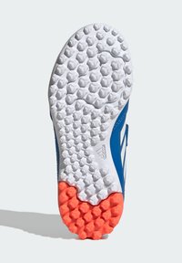 Adidas sports shoe sole features a textured white rubber surface with hexagonal studs, blue accents, and a bright orange section at the heel.