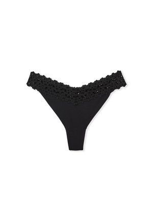 String noir en dentelle florale à la taille et en tissu doux, avec une coupe taille basse et une couverture minimale.