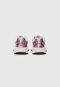 Pink metallic sneakers featuring a textured design, soft white collar, and black rubber sole. Embossed accents and sporty silhouette.