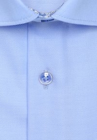 Chemise bleu clair à boutons avec col traditionnel, rayures verticales et bouton rond bleu orné d'un motif floral.