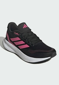 Black athletic shoe with pink accents and three stripes, featuring a mesh upper, textured finish, and white rubber sole labeled "CLOUDFOAM."