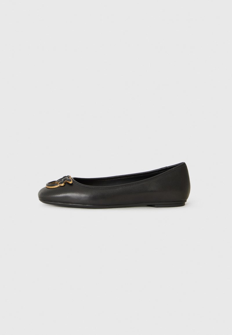 Black leather flat shoe with low heel and gold-accented butterfly decoration on the toe, shown in side view on a plain background.