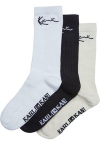 Drei Paar Socken: weiß, schwarz und creme. Jede Socke hat eine gerippte Textur und ein gesticktes "Karl Kani"-Logo am Knöchel.