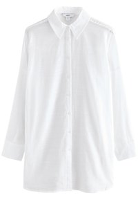 Fehér, gombos ing klasszikus gallérral, hosszú ujjal és struktúrált anyaggal. Egyenes szabású és finom varrásdíszítéssel a vállakon.