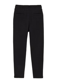 Svarta mjukisbyxor av mjukt tyg med elastisk midjeband, två framfickor och smalnande ben.