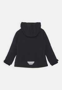 Black hooded jacket with a textured finish, featuring long sleeves and a reflective triangle design at the back hem.