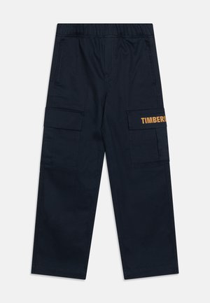 Meremehed sinised kottepüksid elastse vöökohtaga, kahe küljetaskuga ja vasakul jalal oranž "TIMBERLAND" tekst.