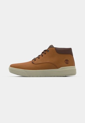 Brown leather ankle boots with a smooth texture, round toe, lace-up design, and a light beige sole. Includes a small tree logo on the side.