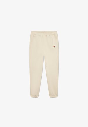 Pantaloni de trening bej cu talie elastică și mansete, având două buzunare laterale și un mic design floral brodat pe față.