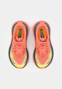 Orange and yellow running shoes with a textured upper, flat laces, and a cushioned sole. Features a distinctive design and logo.