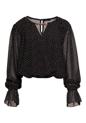 Czarna bluzka z białym wzorem w trójkąty, z balonowymi rękawami i zebranym wykończeniem mankietów. Zapięcie na plecach w kształcie łezki z dekoracyjnym łańcuszkiem. Lekki, prześwitujący materiał.