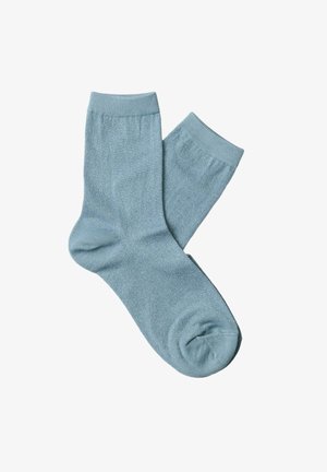 Light blue socks made of soft, textured material. Features a classic ankle length and ribbed cuffs. Smooth finish with subtle sheen.