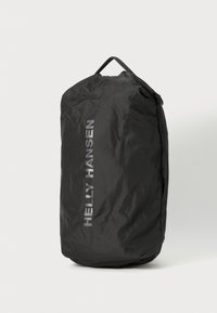 Black pack with a cylindrical shape, made of textured fabric. Features a prominent silver "Helly Hansen" logo on the side and a top handle.