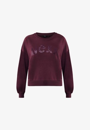 Sweatshirt long rouge à manches longues avec des bords côtelés et un ourlet, arborant un logo "MEXX" en sequins sur la poitrine.