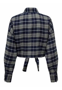Camicia a quadri tagliata in blu navy e bianco, con colletto, maniche lunghe e design legato dietro. Realizzata in un tessuto morbido e testurizzato.