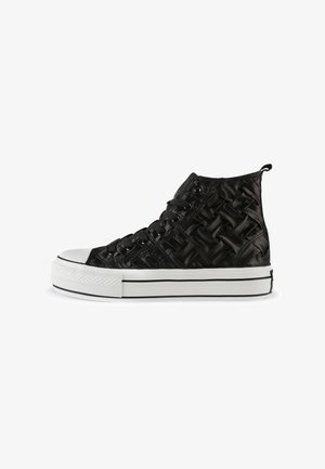 Black high-top sneaker with quilted woven texture, white rubber toe cap, and thick white sole with black stripes.