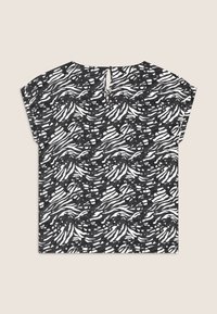 Haut à manches courtes noir et blanc rayé avec une coupe ample, présentant une ouverture en forme de clé au dos et un motif texturé.