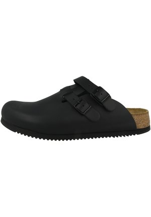 Black clogs with two adjustable buckles, made of matte material. Cork footbed, textured sole, and a rounded toe design.