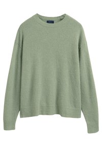 Maglione verde chiaro realizzato in tessuto morbido e lavorato, con scollatura a girocollo, spalle abbassate e orlo e polsini a costine.
