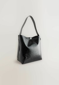 Black leather tote bag with a smooth, shiny texture. Features a wide, curved opening and a single, flat shoulder strap.