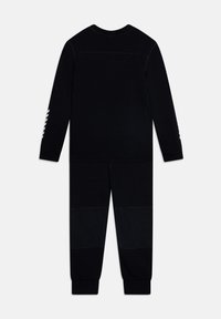Set di maglia a maniche lunghe e pantaloni neri realizzato in tessuto morbido. Presenta polsini a costine e dettagli lungo le maniche con un motivo testurizzato.