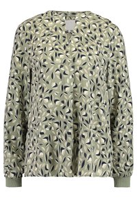 Blouse vert clair avec un motif floral en bleu marine, crème et vert foncé. Encolure arrondie, manches longues avec poignets élastiqués, coupe décontractée.