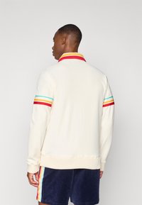 Sergio Tacchini SLICE TRACK JACKET - Veste de survêtement - gardenia/gold