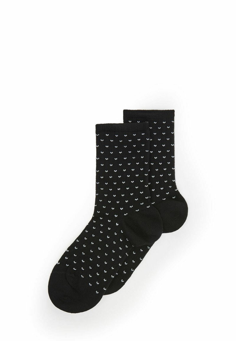 Calze nere in cotone con un piccolo motivo bianco ripetuto. Lunghezza alla caviglia con punta e tallone rinforzati per una maggiore durata.