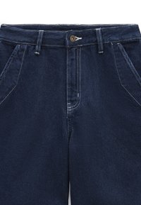 Denim trousers in dark blue with a button closure, front pockets, and contrasting white stitching details. Smooth texture and straight-leg design.