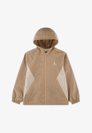Beiger Windbreaker mit Kapuze, Frontreißverschluss, weißen Seitenteilen, elastischen Bündchen und einem kleinen weißen Jordan-Logo auf der linken Brust.